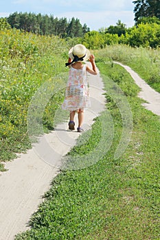 Cute little girl running in the meadow. Children, travel concept.