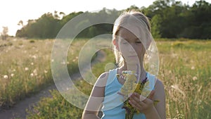 Cute little girl running in a meadow in the colors of a flowers. Carefree childhood - little child girl play on summer