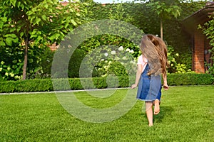 Cute little girl running in park on summer day