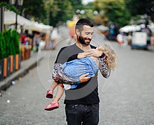 Cute little girl`s sleeping in her father`s arm