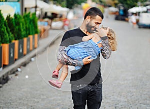 Cute little girl`s sleeping in her father`s arm