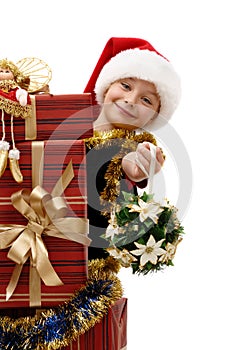 Cute little girl in a Santa Claus cap with Christmas gifts, isolated