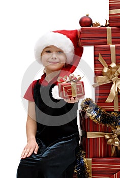 Cute little girl in a Santa Claus cap with Christmas gifts, isolated