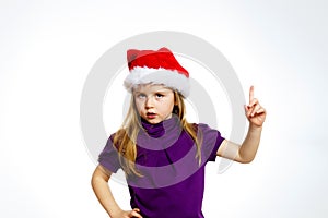 Cute little girl in santa hat touching transparent screen