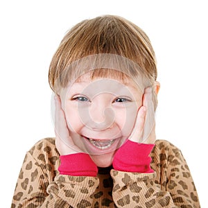 Cute little girl in shirt holding hands to face in surprise