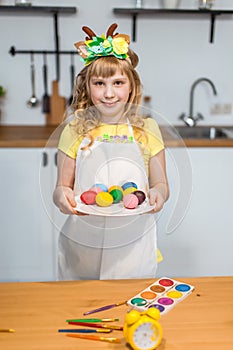 Cute little girl show painted Easter multicolor eggs