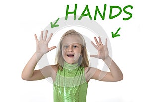 Cute little girl showing hands in body parts learning English words at school