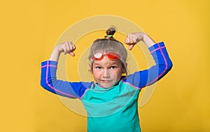 Cute little girl shows biceps. Funny strong child shows muscles. Strong and healthy child can swim in water park
