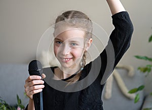 Cute little girl singing karaoke.