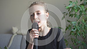 Cute little girl singing karaoke.