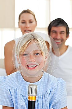 Cute little girl singing with a microphone