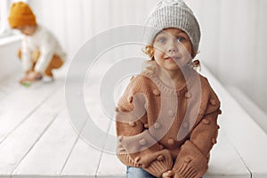 Cute little girl sitting in a studio photo