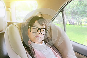 Cute little girl sleeping in car seat