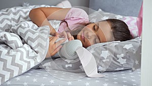 Cute little girl sleeping with her toy