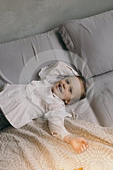 Cute little girl smilling on a bed