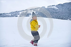 Cute little girl on snow winter nature. Funny kid in winter clothes. Children play outdoors in snow. Kids Christmas
