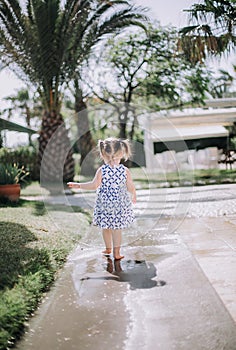 Cute little girl spanking in puddles