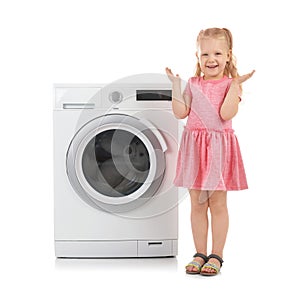 Cute little girl standing near washing machine on white background.