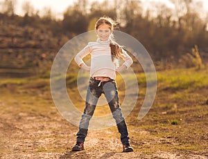 Cute little girl standing on a road