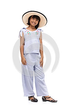 Cute little girl standing in swimming wear and hat on white background