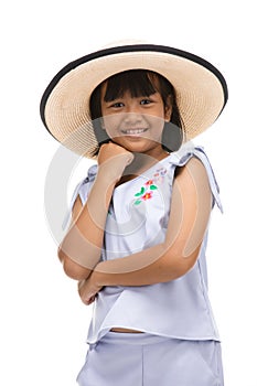Cute little girl standing in swimming wear and hat on white background