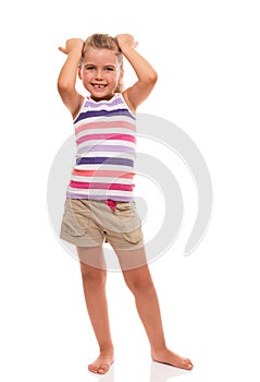 Cute little girl standing on white whith hands on her head