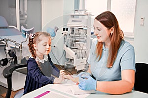 Cute little girl studying female reproductive system with doctor.