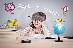 Cute little girl studying at the library and thinking, school concept