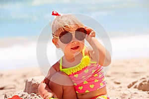 Cute little girl with sunglasses play at beach