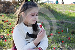 Portrait of a cute little girl in sunny summer day at green nature background. Summer joy - lovely girl blowing dandelion.