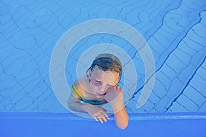 Cute little girl in the swimming pool. Portrait of little cute girl in the swimming pool. Sunny summer day. Summer and happy chil