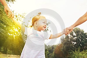 Cute little girl take hands with her relatives people. Walking with kids concept image