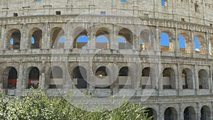 Cute little girl taking pictures of the Colosseum