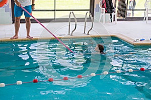 cute little girl taking a swimming lesson in a swimming pool little girl learning to swim in a swimming club