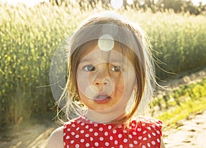 Cute Little girl thinking at sunset