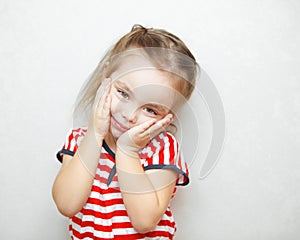 Cute little girl with touched facial expression portrait