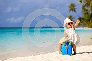 Cute little girl travel on summer beach