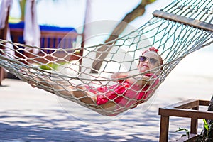 Cute little girl on tropical vacation relaxing in