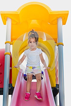 Cute little girl trying to walk on slider