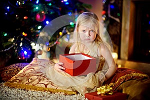 Cute little girl is unhappy with her Christmas gift