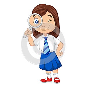 Cute little girl in uniform using magnifying glass