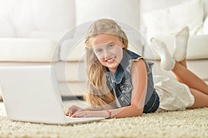 Cute little girl using laptop