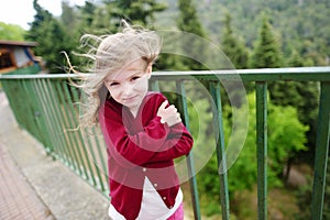 Cute little girl on a very windy day photo