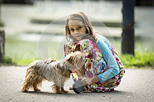 Cute little girl on a walk with her doggy. Love.