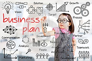 Cute little girl wearing business dress and writing business plan concept. Office background.