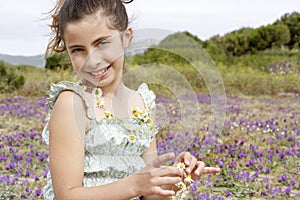 Cute Little Girl Wearing And Holding Necklace Of Flowers