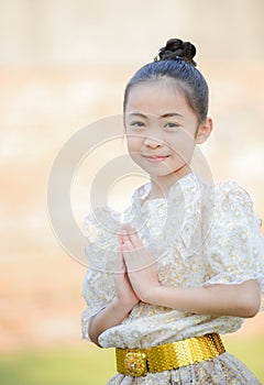 Cute little girl wearing thai dress pay respect