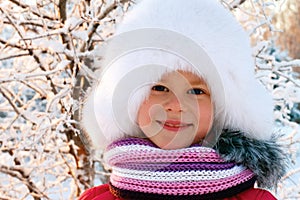 Cute little girl in a white fluffy hat