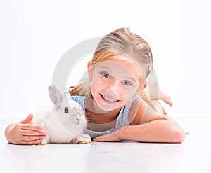 Cute little girl a white rabbit