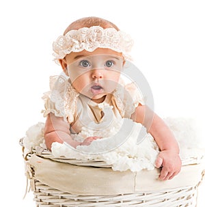 Cute little girl in a wicker basket